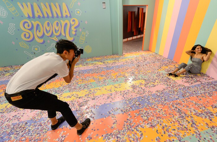 (Francisco Kjolseth  |  The Salt Lake Tribune)  Riley Gracie poses for Christian Phomsouvanh in the cereal room at Hall of Breakfast, a quirky new art exhibit that celebrates the first meal of the day. The exhibit runs through July 9 at The Gateway.