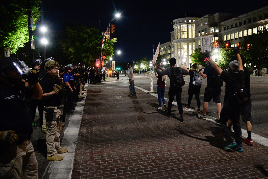 (Francisco Kjolseth  |  The Salt Lake Tribune) Protesters walk down State Street in Salt Lake City as police line up to enforce a mandatory curfew on Monday, June 1, 2020, following violence and unrest over the weekend due to the death of George Floyd by police.