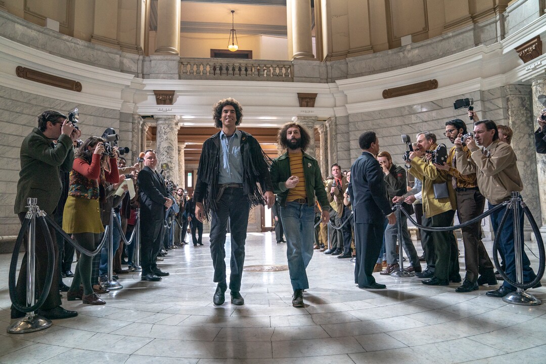 (Niko Tavernise  |  Netflix) Sacha Baron Cohen, left, plays Abbie Hoffman and Jeremy Strong plays Jerry Rubin in "The Trial of the Chicago 7," a courtroom drama following the prosecution of anti-war activists in 1968, directed and written by Aaron Sorkin.