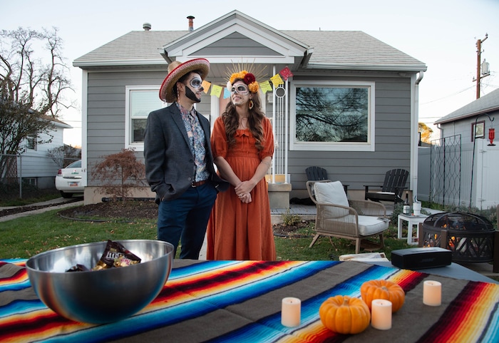 (Francisco Kjolseth  |  The Salt Lake Tribune) Nate and Annie Hrivnak wait for trick or treaters outside their home as they sing up for the SugarHood Halloween as a treat giving household agreeing to abide by CDC Covid safety standards on Saturday, Oct. 31, 2020.