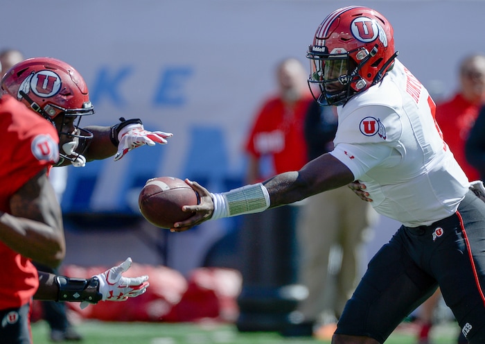(Francisco Kjolseth  |  The Salt Lake Tribune)  Quarterback Tyler Huntley, #1, passes off the ball to a teammate as he scrimmages with the team during spring practice at Rice Eccles stadium, the first of two major scrimmages prior to the April 13 Red-White Game. Huntley will face his first big test since he was injured Nov. 3 at Arizona State. 