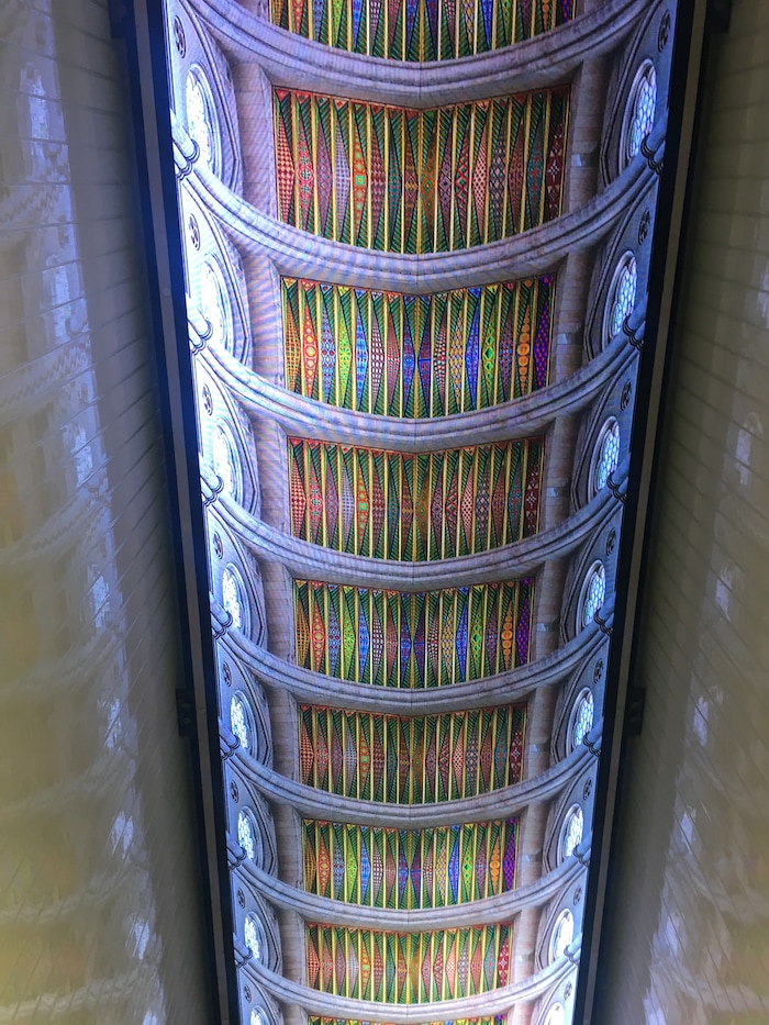 A giant video wall shows images of stained glass on the first floor of the new Museum of the Bible in Washington, D.C.