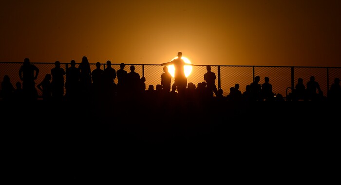 (Scott Sommerdorf | The Salt Lake Tribune) Corner Canyon fans watch as the sun sets behind them as their team led Pleasant Grove 14-3 at the half, Friday, August 18, 2017.