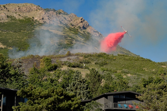 (Francisco Kjolseth  |  The Salt Lake Tribune) Fire crews battle a fire near Millcreek Canyon, on Saturday, July 11, 2020, started near 3400 South Crestwood Dr., as helicopters, single engine air tankers and multiple crews respond.