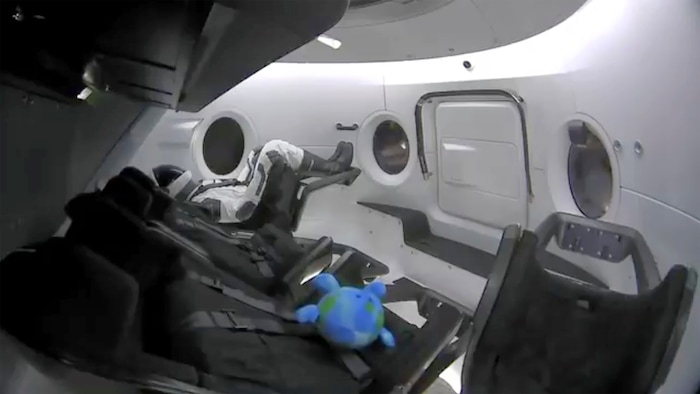 This photo provided by SpaceX shows a life-size test dummy along with a toy that is floating in the Dragon capsule as the capsule made orbit on Saturday, March 2, 2019.   America's newest capsule for astronauts rocketed toward the International Space Station on a high-stakes test flight by SpaceX.  This latest, flashiest Dragon is on a fast track to reach the space station Sunday morning, just 27 hours after liftoff.  (SpaceX via AP)