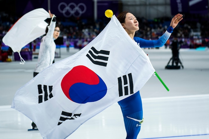 (Chris Detrick  |  The Salt Lake Tribune)  Korea's Sang-Hwa Lee and Japan's Nao Kodaira wave to the crowd after the Ladies' 500m at the Gangneung Oval during the Pyeongchang 2018 Winter Olympics Sunday, Feb. 18, 2018. Lee finished in 2nd place with a time of 37.33. Kodaira won the event with a time of 36.94.