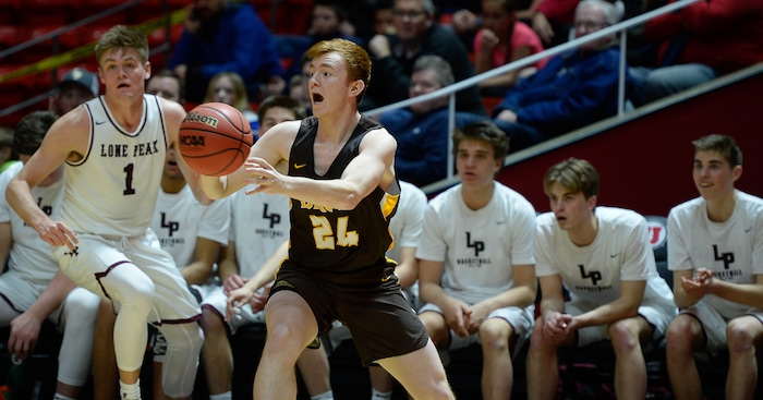 (Francisco Kjolseth  |  The Salt Lake Tribune)  Davis vs Lone Peak, 6A State high school basketball tournament at the Huntsman Center in Salt Lake City, Thursday March 1, 2018. Trey Grossenbach (24) passes the ball in front of the Lone Peak bench. 