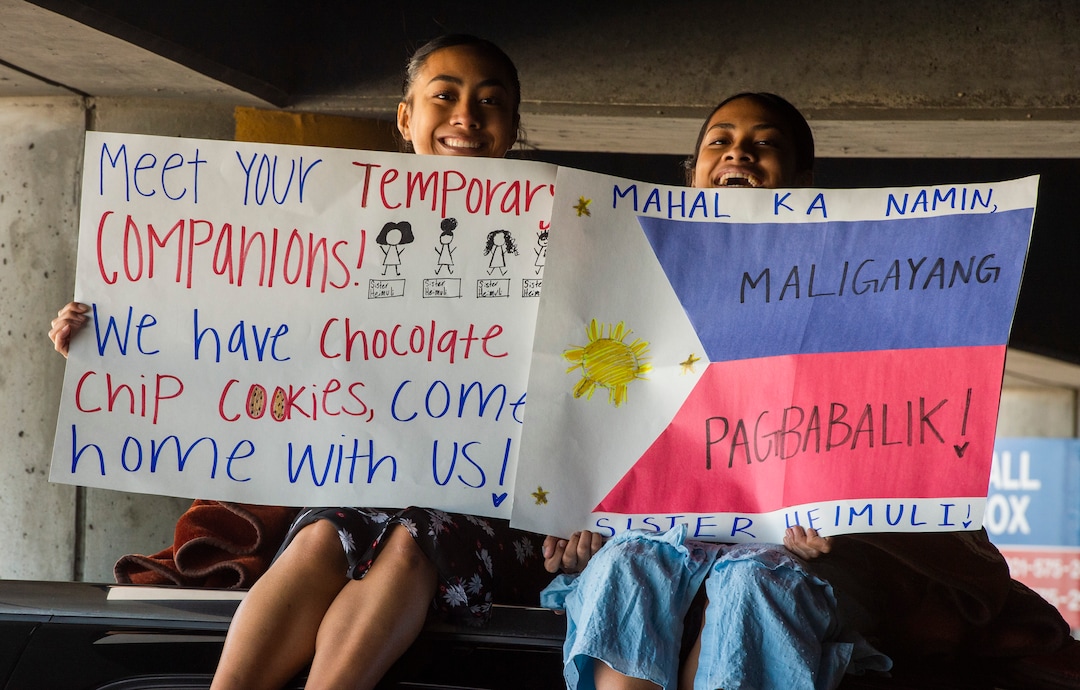 (Rick Egan  |  The Salt Lake Tribune)       Twin sisters, Susi and Britney Heimuli form Saratoga Springs, wait for their sister as she returns from the Philippines, at the Salt Lake City International Airport, Sunday, March 22, 2020.