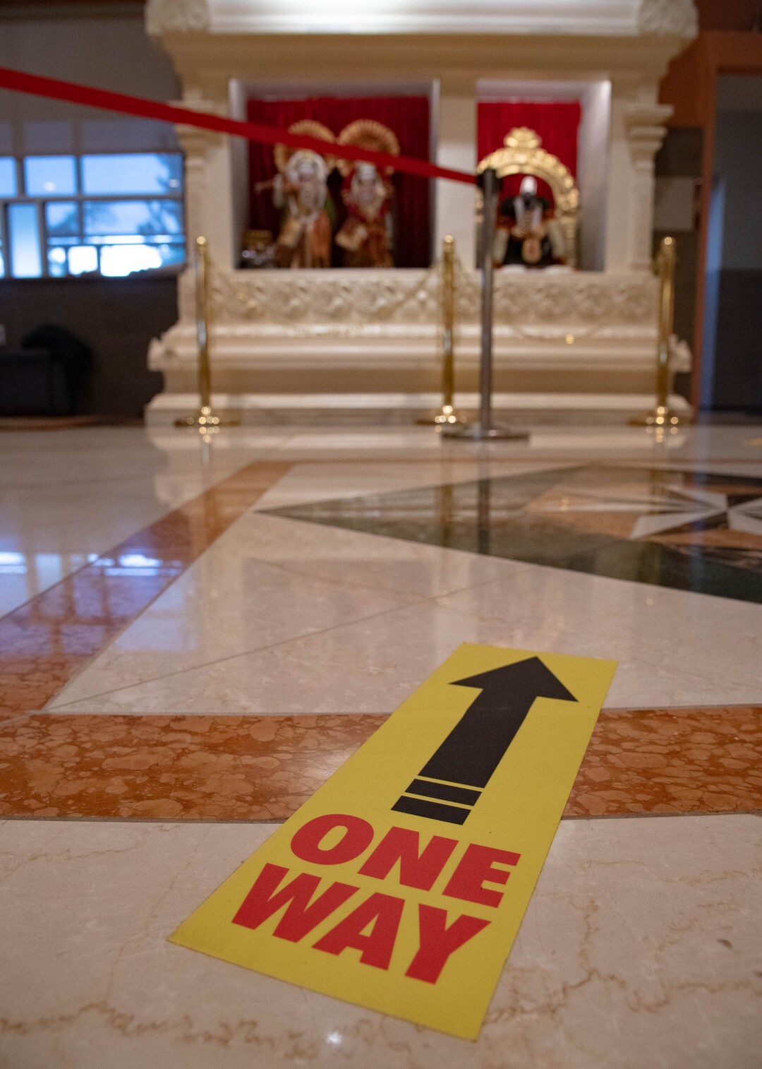 (Francisco Kjolseth  |  The Salt Lake Tribune) Stickers promoting social distancing and flow of traffic are placed on the ground inside the Sri Ganesha Hindu Temple in South Jordan in an effort to maintain safety during the coronavirus pandemic. Thought the temple remains closed on weekdays, a few slots are available for signup on the weekend under limited hours.