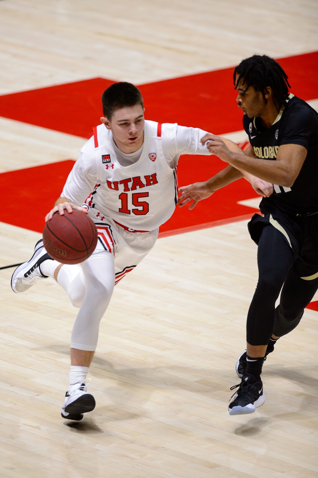 (Trent Nelson  |  The Salt Lake Tribune) Utah Utes guard Rylan Jones (15) defended by Colorado Buffaloes guard Keeshawn Barthelemy (11) as Utah hosts Colorado, NCAA basketball in Salt Lake City on Monday, Jan. 11, 2021.