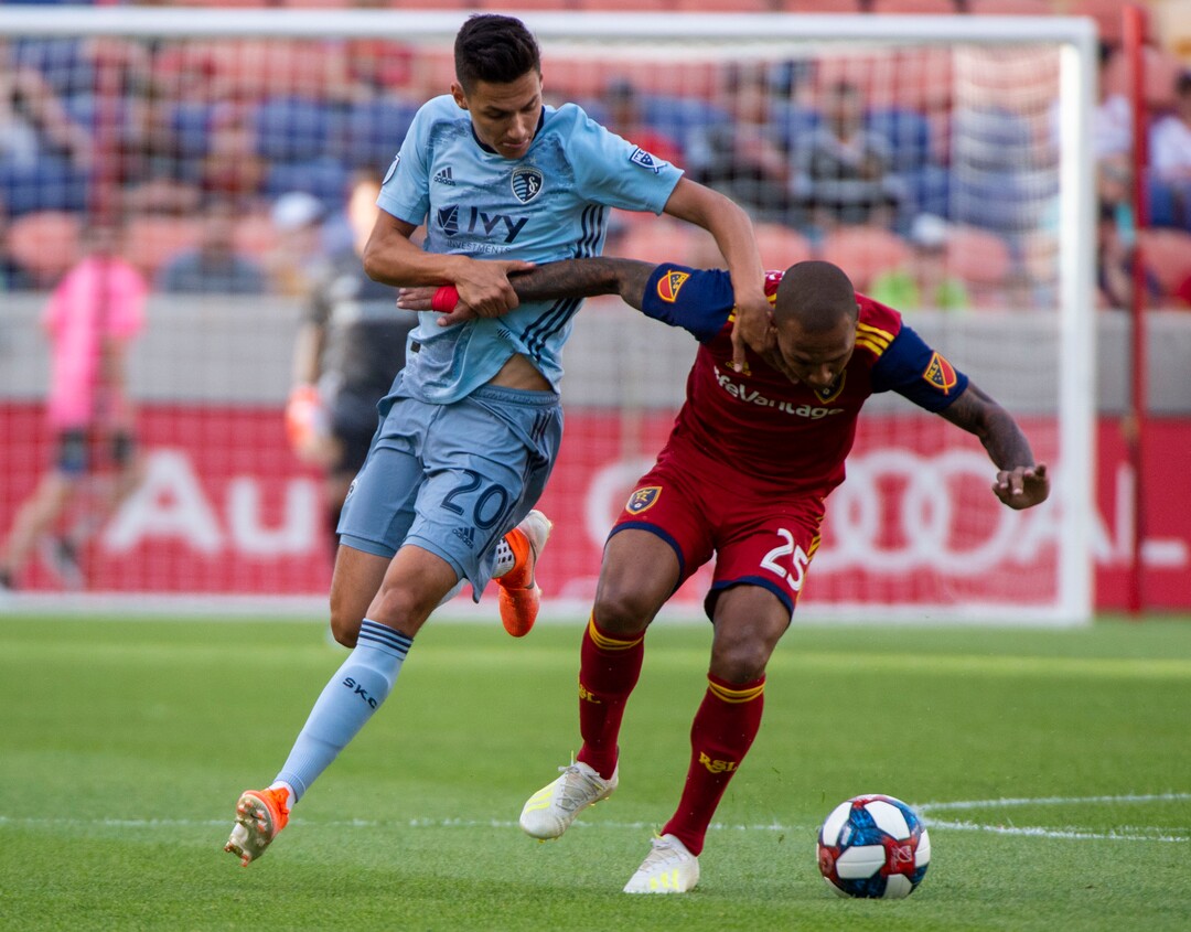 (Rick Egan  |  The Salt Lake Tribune)  Real Salt Lake midfielder Sebastian Saucedo (23) collides with Sporting Kansas City forward Daniel Salloi (20), in MLS soccer action between Real Salt Lake and Sporting Kansas City, in Sandy, Saturday, June 29, 2019.