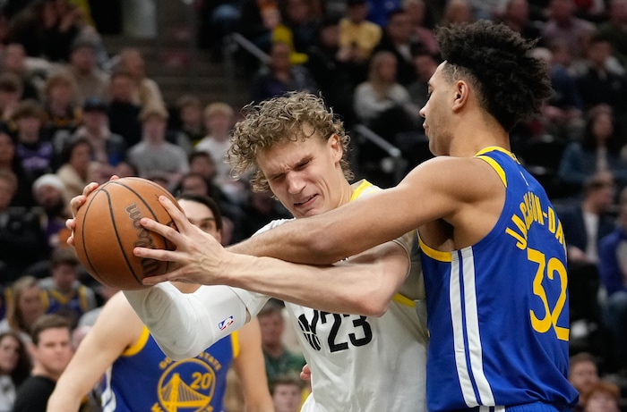 (Francisco Kjolseth  |  The Salt Lake Tribune) Utah Jazz forward Lauri Markkanen (23) tries to muscle the ball past Golden State Warriors forward Trayce Jackson-Davis (32) during an NBA basketball game Thursday, Feb. 15, 2024, in Salt Lake City.