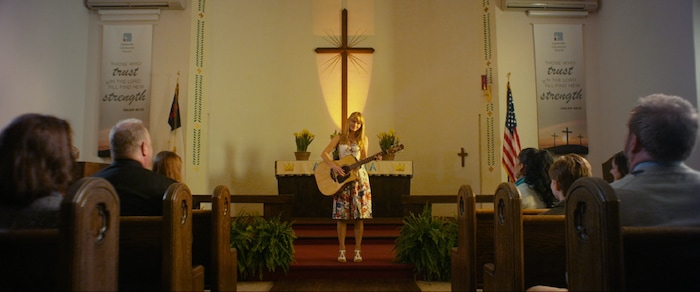 (photo courtesy Freestyle Releasing) Amber (Lindsay Pulsipher) prepares to sing in church for the first time in years, in the drama "God Bless the Broken Road."
