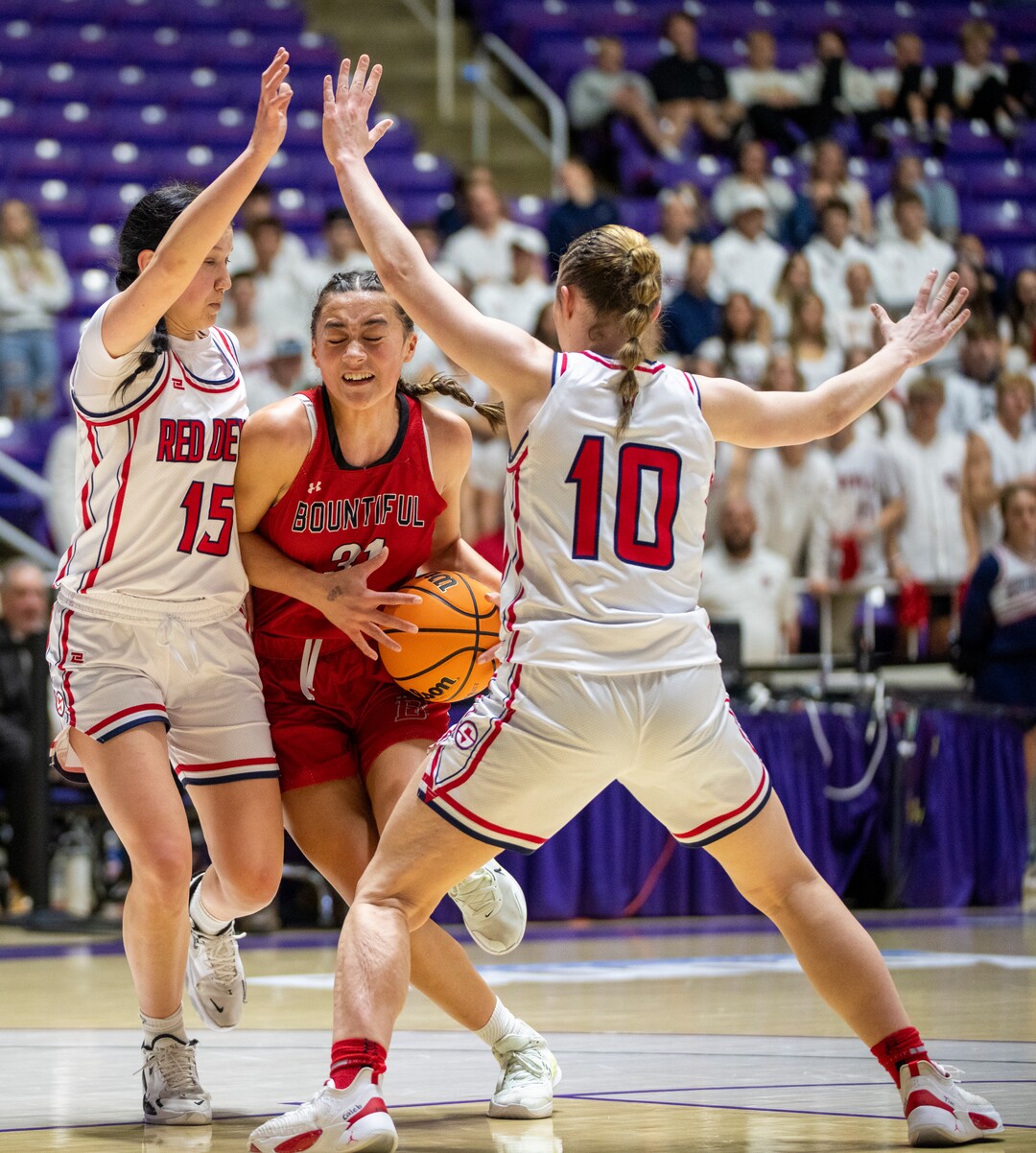 (Rick Egan | The Salt Lake Tribune) Bountiful Redhawks Milika Satuala, tries to split Springville Red Devil defenders Katie Durfey and Kayla  Porray, in the Girls 5A State Championship between the Springville Red Devils and the Bountiful Redhawks, at Weber State, on Saturday, March 4, 2023.