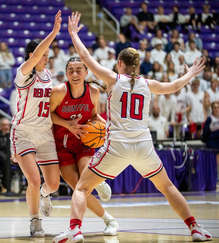 (Rick Egan | The Salt Lake Tribune) Bountiful Redhawks Milika Satuala, tries to split Springville Red Devil defenders Katie Durfey and Kayla  Porray, in the Girls 5A State Championship between the Springville Red Devils and the Bountiful Redhawks, at Weber State, on Saturday, March 4, 2023.
