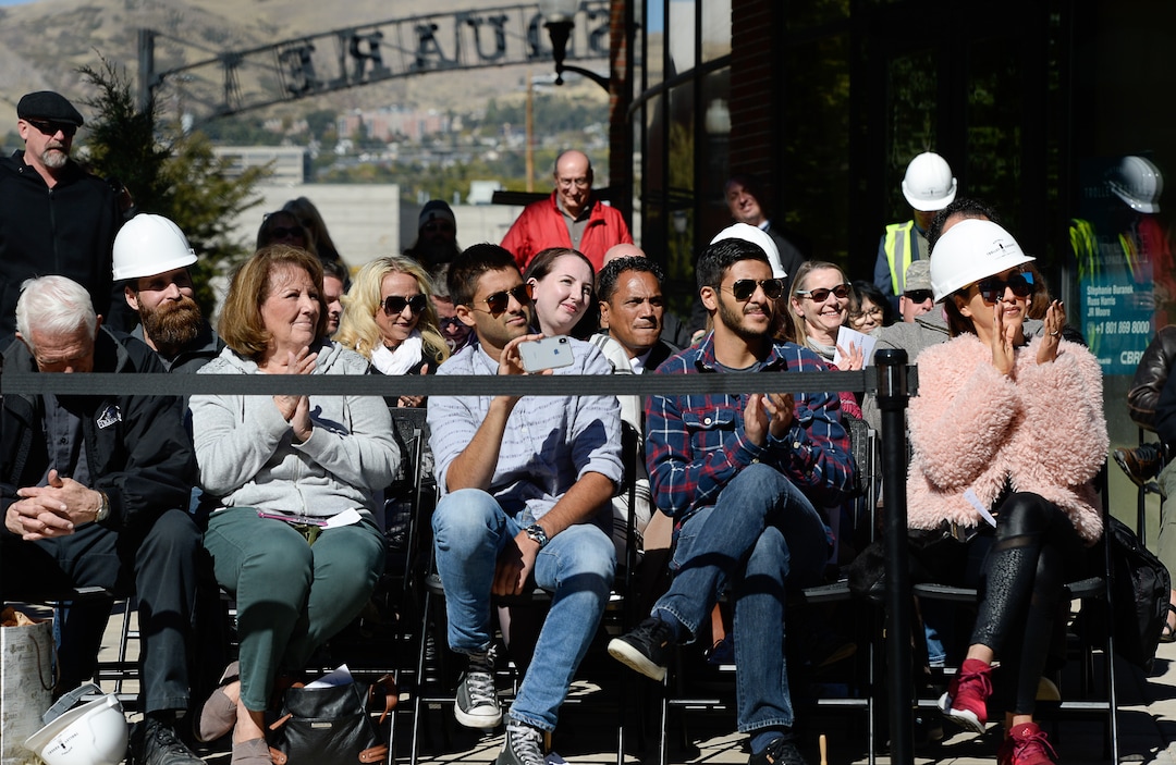 (Francisco Kjolseth  |  The Salt Lake Tribune  People gather to witness the iconic trolley car, that has been sitting in storage for several years, as it is moved back into view at Trolley Square on Monday, Oct. 15, 2018. The empty trolley car, last seen housing the Trolley Wing Company was moved into place on the north plaza by Pottery Barn.