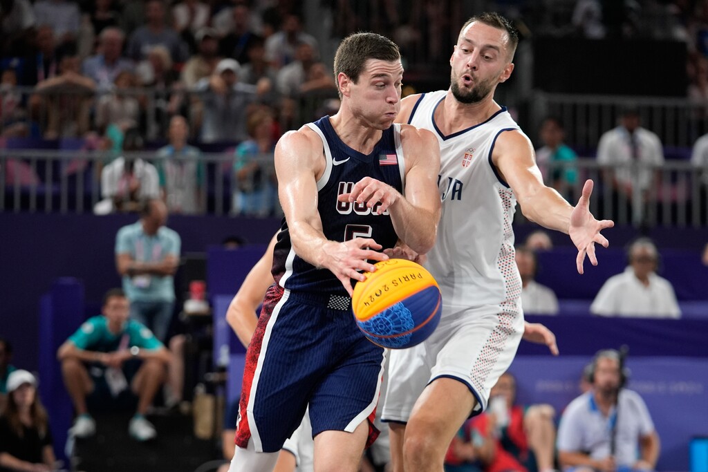 (Rebecca Blackwell | AP) Jimmer Fredette of the United States comes under pressure from Marko Brankovic of Serbia in the men's 3x3 basketball pool round match between Serbia and the United States at the 2024 Summer Olympics, Tuesday, July 30, 2024, in Paris.