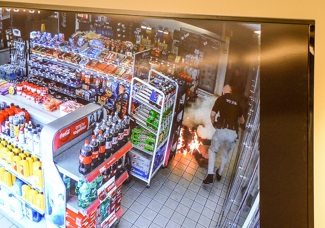 (Francisco Kjolseth  |  The Salt Lake Tribune)  Kaysville Officer Cade Bradshaw, right, steps back from a suicidal burning man, moments after he lit himself on fire after dousing himself with gasoline inside a convenience store gas station on April 5, 2018, subsequently burning several officers who were trying to calm him down. The Kaysville police department aired the surveillance footage during a press event featuring the officers involved.