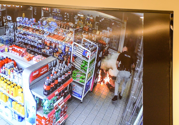 (Francisco Kjolseth  |  The Salt Lake Tribune)  Kaysville Officer Cade Bradshaw, right, steps back from a suicidal burning man, moments after he lit himself on fire after dousing himself with gasoline inside a convenience store gas station on April 5, 2018, subsequently burning several officers who were trying to calm him down. The Kaysville police department aired the surveillance footage during a press event featuring the officers involved.