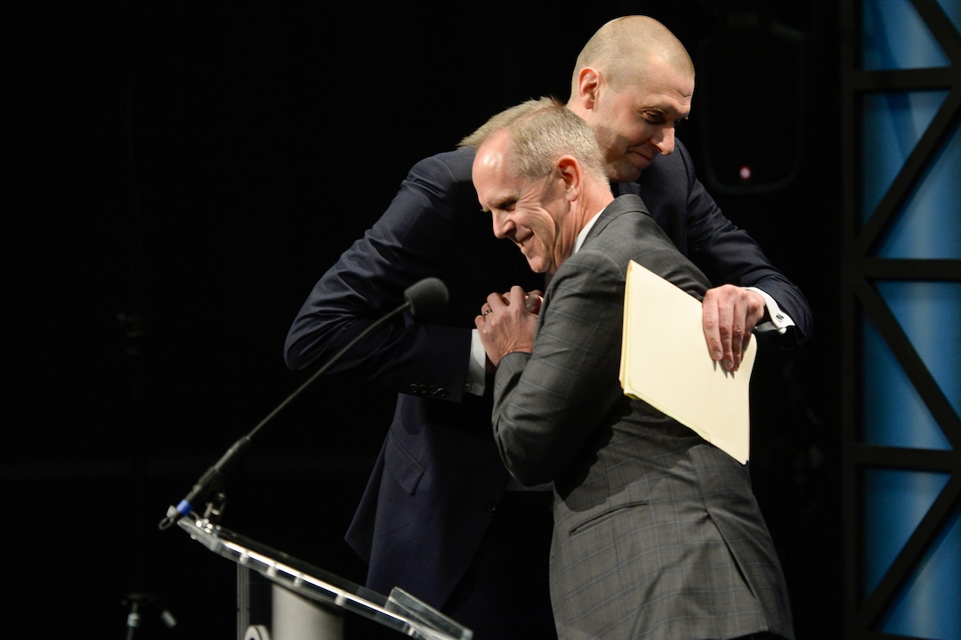 (Francisco Kjolseth  |  The Salt Lake Tribune)  Mark Pope is embraced by Athletic Director Tom Holmoe as he is brought into the BYU family after being introduced as its new head basketball coach during a press event at the BYU broadcasting building on Wed. April 10, 2019.
