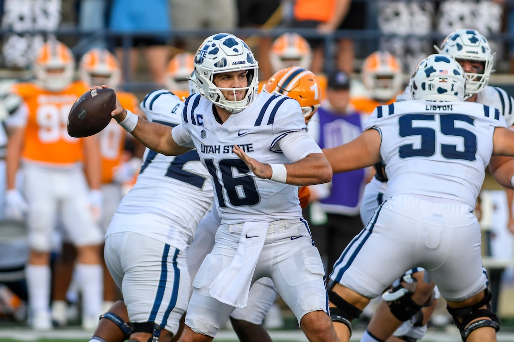 (Tyler Tate | AP) Utah State quarterback Bryson Barnes (16) looks to pass the ball during a game against UTEP.