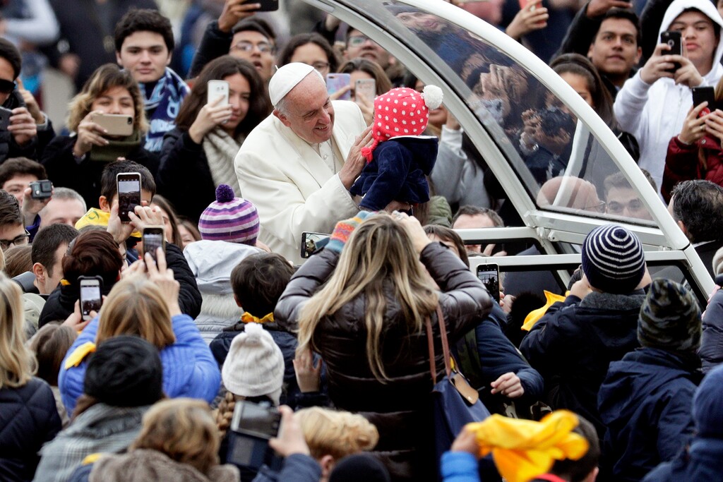 (AP Photo/Andrew Medichini) Pope Francis caresses a baby as he arrives for his weekly general audience, in St. Peter's Square, at the Vatican, Wednesday, Jan. 31, 2018.