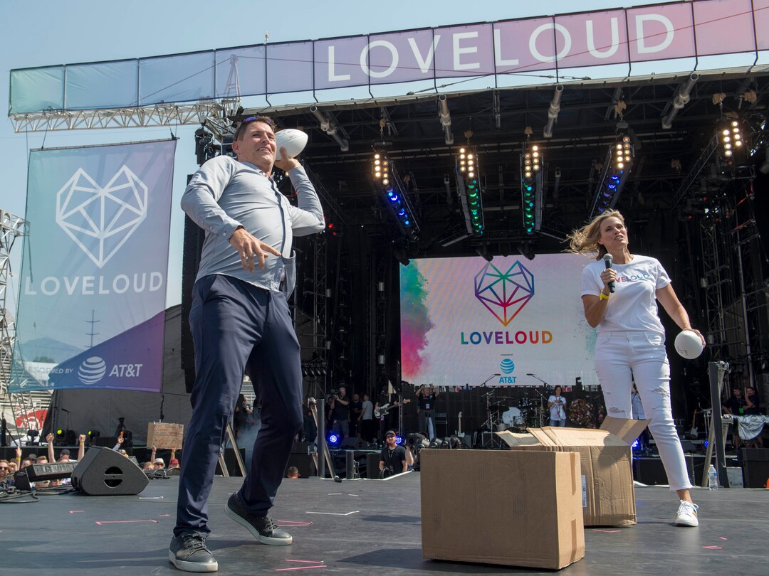 (Rick Egan  |  The Salt Lake Tribune)     Steve Young tosses footballs in to the crowd with the assistance of his wife Barb, at the Loveloud Festival at Rice-Eccles Stadium, Saturday, July 28, 2018.