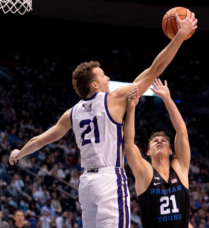 (Francisco Kjolseth | The Salt Lake Tribune) Westminster Griffins forward Lewis Johnson (21) reaches out for a rebound over Brigham Young Cougars guard Trevin Knell (21) in basketball action between the Brigham Young Cougars and the Westminster Griffins at the Marriott Center in Provo, Wednesday, Dec. 29, 2021.