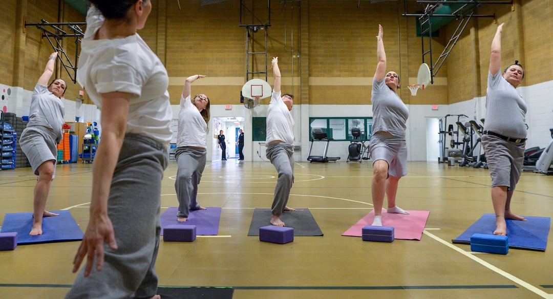Leah Hogsten  |  The Salt Lake Tribune  Yoga instructor apprectice Ferosa Bluff leads a yoga class at the Timpanogos WomenÕs Correctional Facility gymnasium at the Utah State Prison. ÒYou can have a positive experience in a place that is known for a negative connotation," said Bluff. "Even in a place like this we can find the beauty and peace in something like yoga."