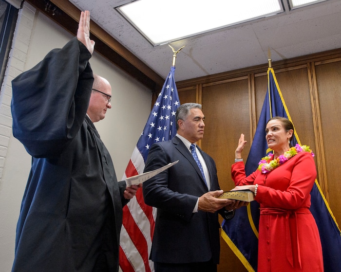 (Steve Griffin | The Salt Lake Tribune) As her husband Steve Kaufusi holds the Bible, Michelle Kaufusi takes the Oath of Office, administered by Judge Vernon Romeny, as she becomes the first female mayor in Provo city's history. The small private ceremony was held in the Mayor's Office in Provo Tuesday January 2, 2018. A public Inauguration Ceremony for Mayor Kaufusi will be held at the Provo Library on January 18, 2018.