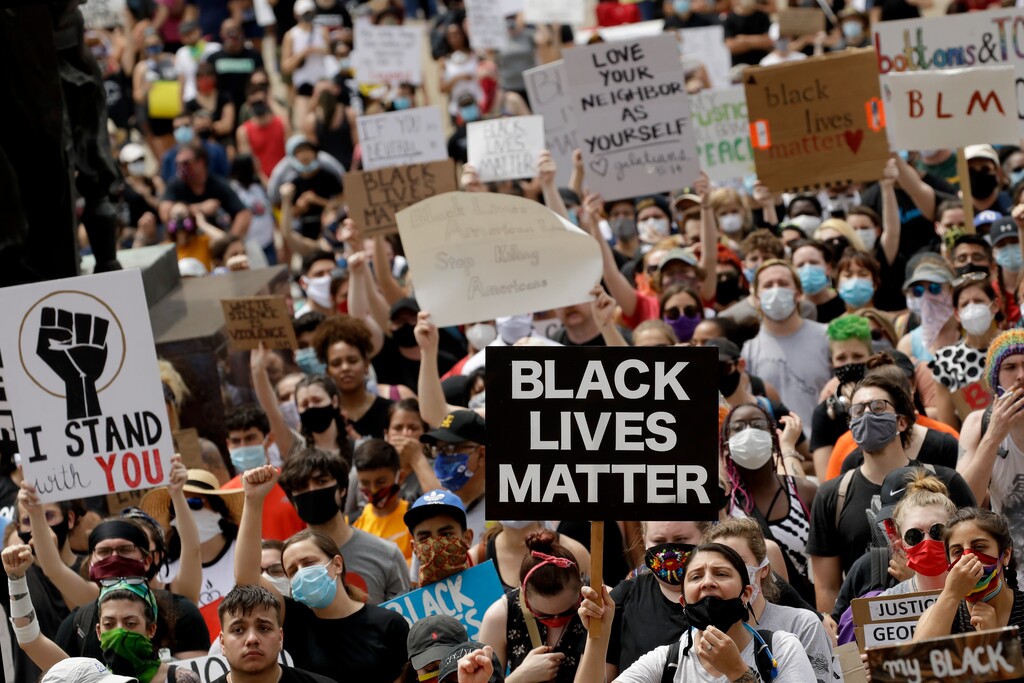 (Charlie Riedel | AP file photo) People listen to a speaker in front of city hall in downtown Kansas City, Mo., on June 5, 2020, during a rally to protest the death of George Floyd who died after being restrained by Minneapolis police officers on May 25. Thousands of Black activists from across the U.S. will hold the 2020 Black National Convention on Aug. 28, 2020, via livestream to produce a new political agenda that builds on the protests that followed George Floyd’s death. Organizers of the gathering shared their plans with The Associated Press on Wednesday, July 1, ahead of an official announcement.