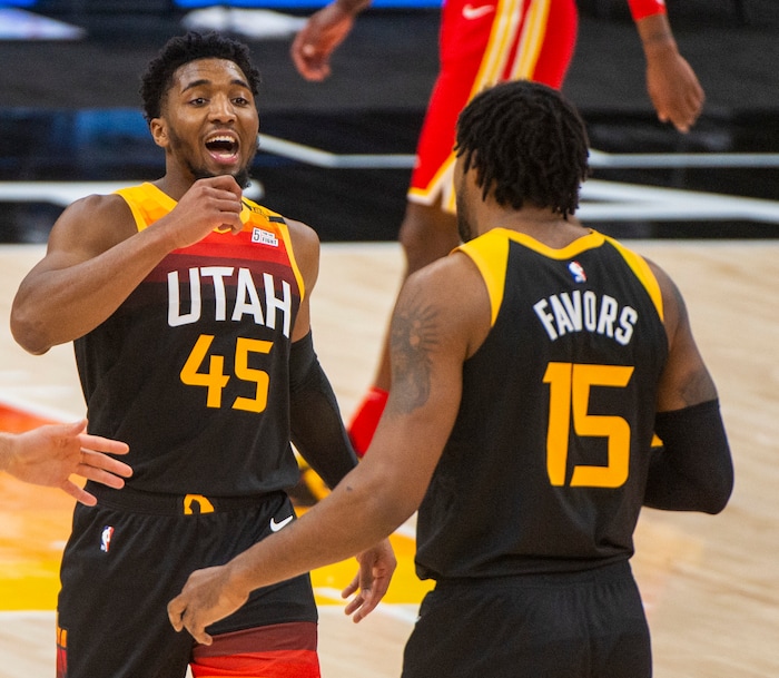 (Rick Egan | The Salt Lake Tribune) Utah Jazz guard Donovan Mitchell (45) and Jazz center Derrick Favors (15), react as the Jazz extend their lead, in NBA action between the Utah Jazz and the Atlanta Hawks at Vivint Arena, on Friday, Jan. 15, 2021.