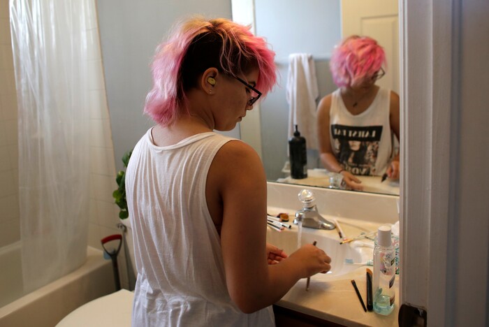 (Lynne Sladky | The Associated Press) In this Thursday, June 22, 2017 photo, Theo Ramos, 15, cleans makeup brushes at home in Homestead, Fla. Ramos is embracing his gender fluidity, meaning that whether he identifies as male or female can change, depending on day or mood.