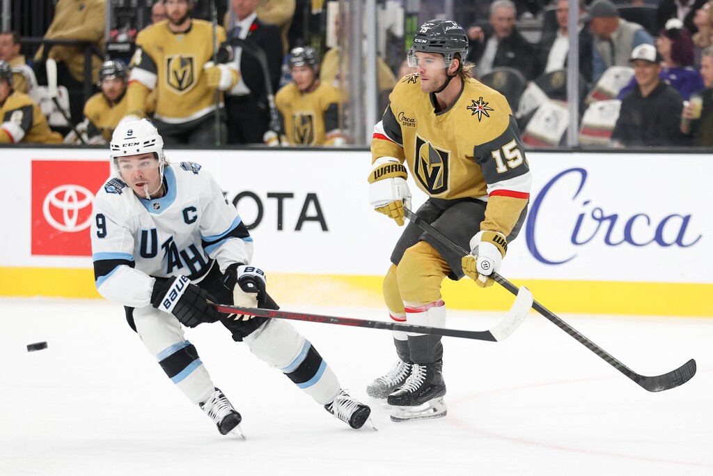 (Ian Maule | AP) Utah Hockey Club center Clayton Keller (9) and Vegas Golden Knights defenseman Noah Hanifin (15) go after a loose puck during the first period of an NHL hockey game Saturday, Nov. 2, 2024, in Las Vegas.