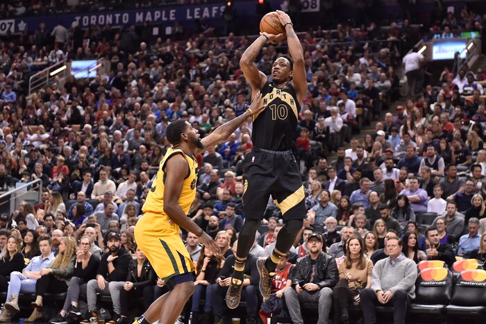 Toronto Raptors guard DeMar DeRozan (10) shoots over Utah Jazz forward Royce O'Neale during the second half of an NBA basketball game Friday, Jan. 26, 2018, in Toronto. (Frank Gunn/The Canadian Press via AP)