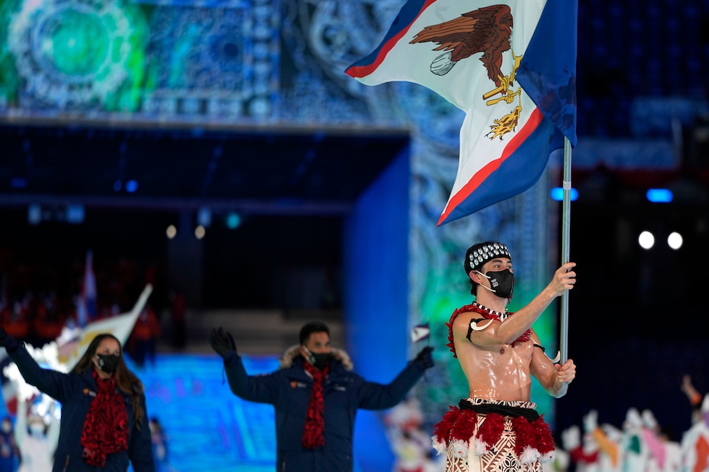 (Jae C. Hong | AP) Nathan Crumpton, of American Samoa, carries his national flag into the stadium during the opening ceremony of the 2022 Winter Olympics, Friday, Feb. 4, 2022, in Beijing.