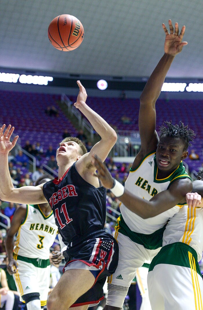 (Leah Hogsten  |  The Salt Lake Tribune) Weber's Austin Bartholomew (11) battles Kearns' Emmanuel Andrew (04) under the net. Weber defeated Kearns 60-52 in the 6A High School Boys' Basketball Tournament opening game at Weber State University’s Dee Events Center in Ogden, Tuesday, Feb. 27, 2018. 