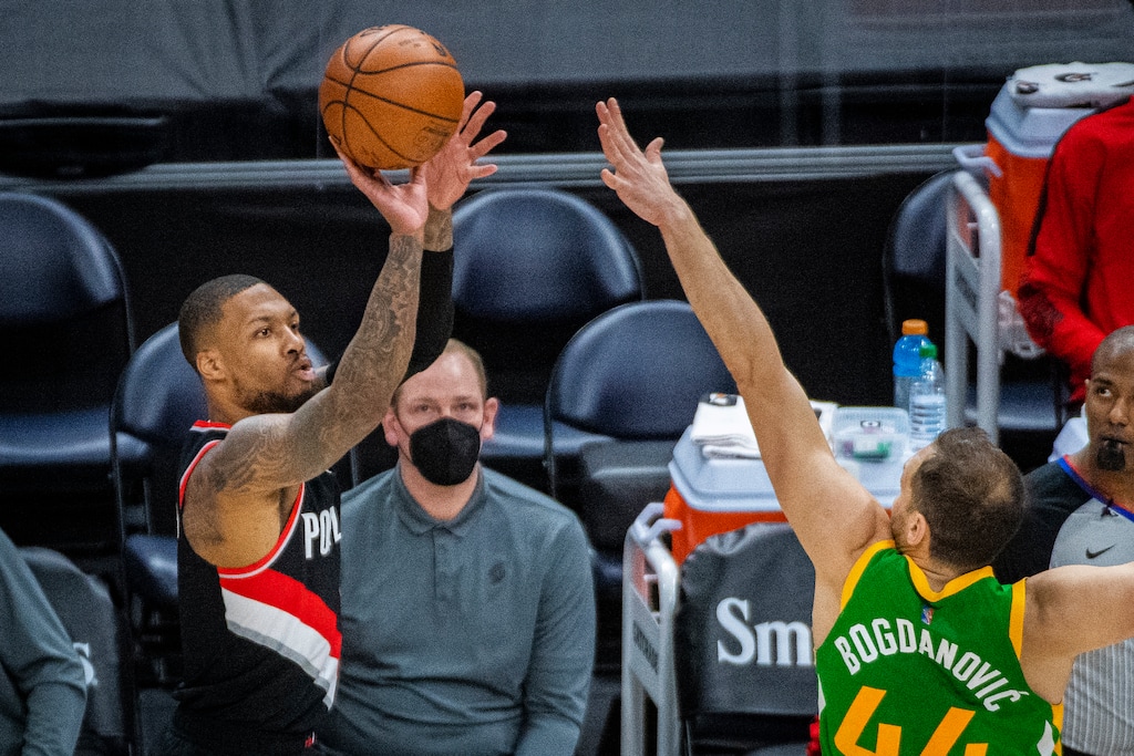 Portland Trail Blazers guard Damian Lillard (0) shoots a 3-pointer against Utah Jazz forward Bojan Bogdanovic (44) during the first half of an NBA basketball game Thursday, April 8, 2021, in Salt Lake City. (AP Photo/Isaac Hale)