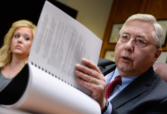 (Francisco Kjolseth | The Salt Lake Tribune) Heather Leyva, listens as her attorney Robert Sykes, discusses the sexual harassment lawsuit he is filing on her behalf against Utah trooper Sgt. Blaine Robbins, during a press conference at his law offices in Salt Lake City Wed. Feb. 7, 2018. According to the lawsuit, the trooper hounded her with unwanted sexually charged messages and used his position and authority to stalk her.
