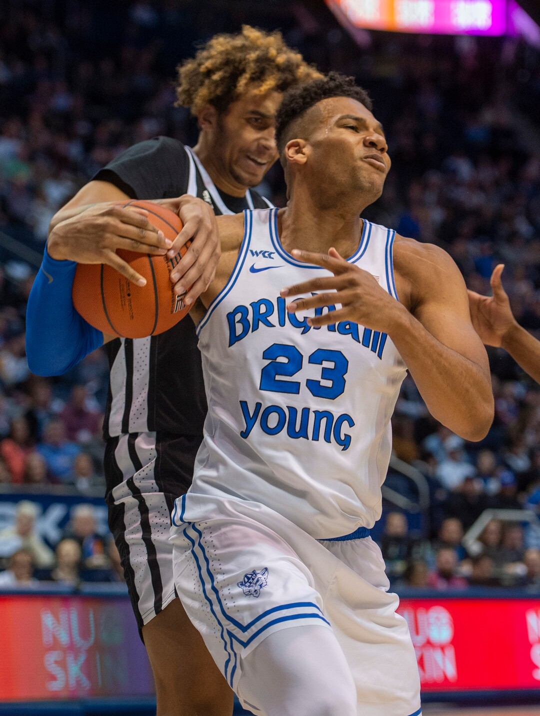 (Rick Egan  |  The Salt Lake Tribune)         Nevada Wolf Pack forward K.J. Hymes (42) gets his hand on the ball as Brigham Young Cougars forward Yoeli Childs (23) tries to keep control, in basketball action between the Brigham Young Cougars and the Nevada Wolf Pack, at the Marriott Center, in Provo, Saturday, December 10, 2019.