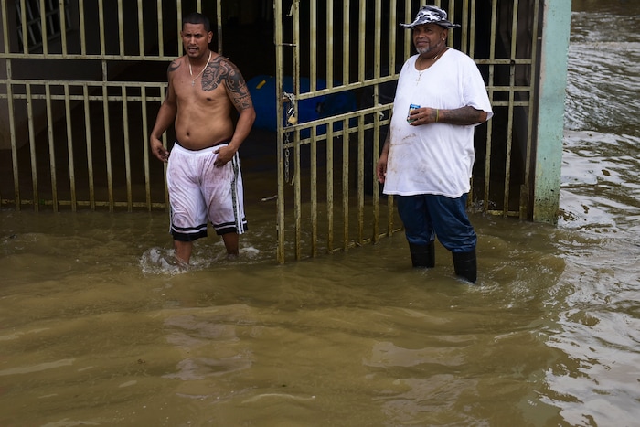 Residents from Ingenio walk through flooded areas after the passing of Hurricane Maria, in Ingenio, Puerto Rico, Friday, September 22, 2017. Because of the heavy rains brought by Maria, thousands of people were evacuated from Toa Baja after the municipal government opened the gates of the Rio La Plata Dam. (AP Photo/Carlos Giusti)