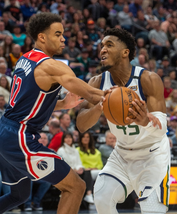 (Rick Egan  |  The Salt Lake Tribune)    Washington Wizards guard Jerome Robinson (12) gets a piece of Utah Jazz guard Donovan Mitchell's arm, in NBA action between the Utah Jazz and the Washington Wizards, in Salt Lake City, Friday, February 28, 2020