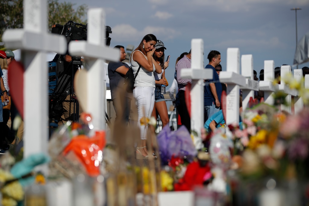 People visit a makeshift memorial, Monday, Aug. 5, 2019, at the site of a mass shooting at a shopping complex, in El Paso, Texas. (AP Photo/John Locher)