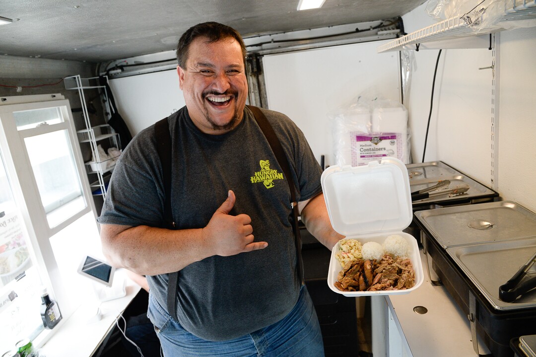 (Francisco Kjolseth  |  The Salt Lake Tribune)  Keni Aikau, owner of the Hungry Hawaiian carries on his father's recipes as he prepares a pork and chicken plate with his father's signature macaroni salad during Food Truck night at Trolley Square draws people in on Wednesday, July 17, 2019. Three of the vendors that showed up, along with four others, will vie for the title of Best New Food Truck on Aug. 3 at the Food Truck and Brewery Battle at The Gateway.