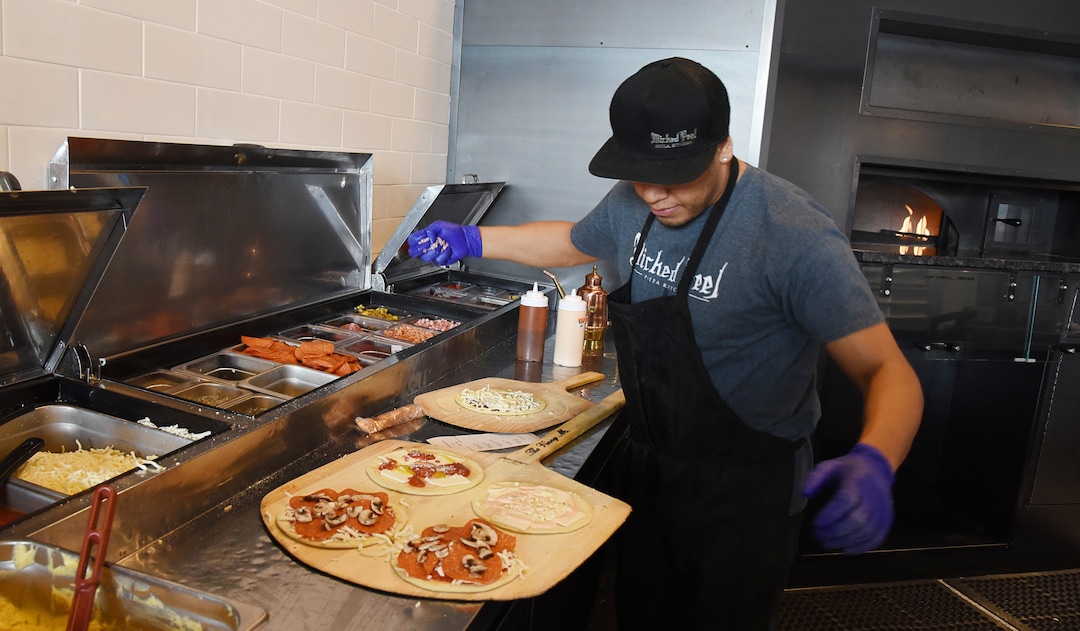 (Francisco Kjolseth  |  The Salt Lake Tribune)  Alex Sanchez assembles the lunch special, kids sized pizza with a side salad at Wicked Peel Pizza Kitchen in Riverton.