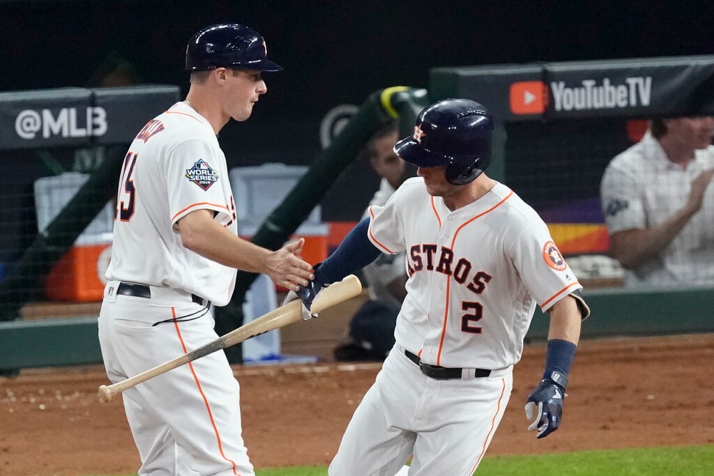 Houston Astros' Alex Bregman hand his bat to first base coach Don Kelly after a home run against the Washington Nationals during the first inning of Game 6 of the baseball World Series Tuesday, Oct. 29, 2019, in Houston. (AP Photo/Eric Gay)
