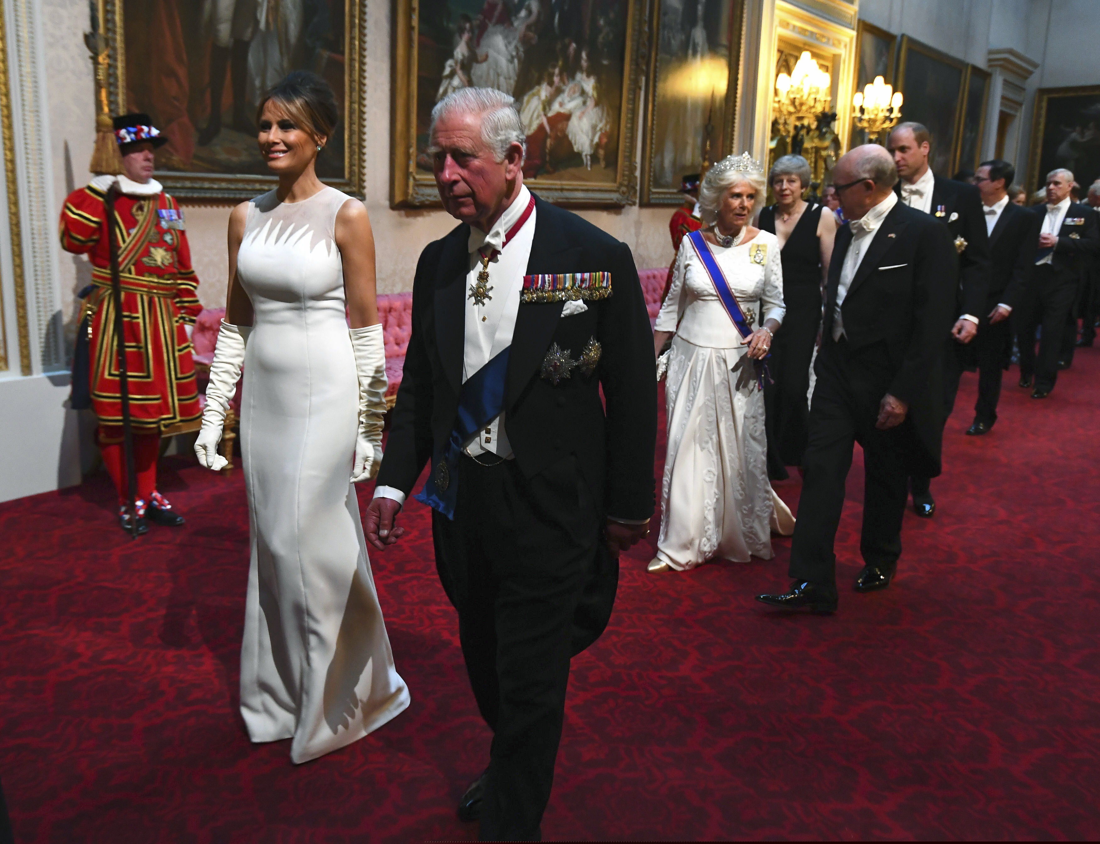 First lady Melania Trump, second left and Britain's Prince Charles arrive through the East Gallery ahead of the State Banquet at Buckingham Palace in London, Monday, June 3, 2019. US President Donald Trump is on a three-day state visit to Britain. (Victoria Jones/Pool Photo via AP)