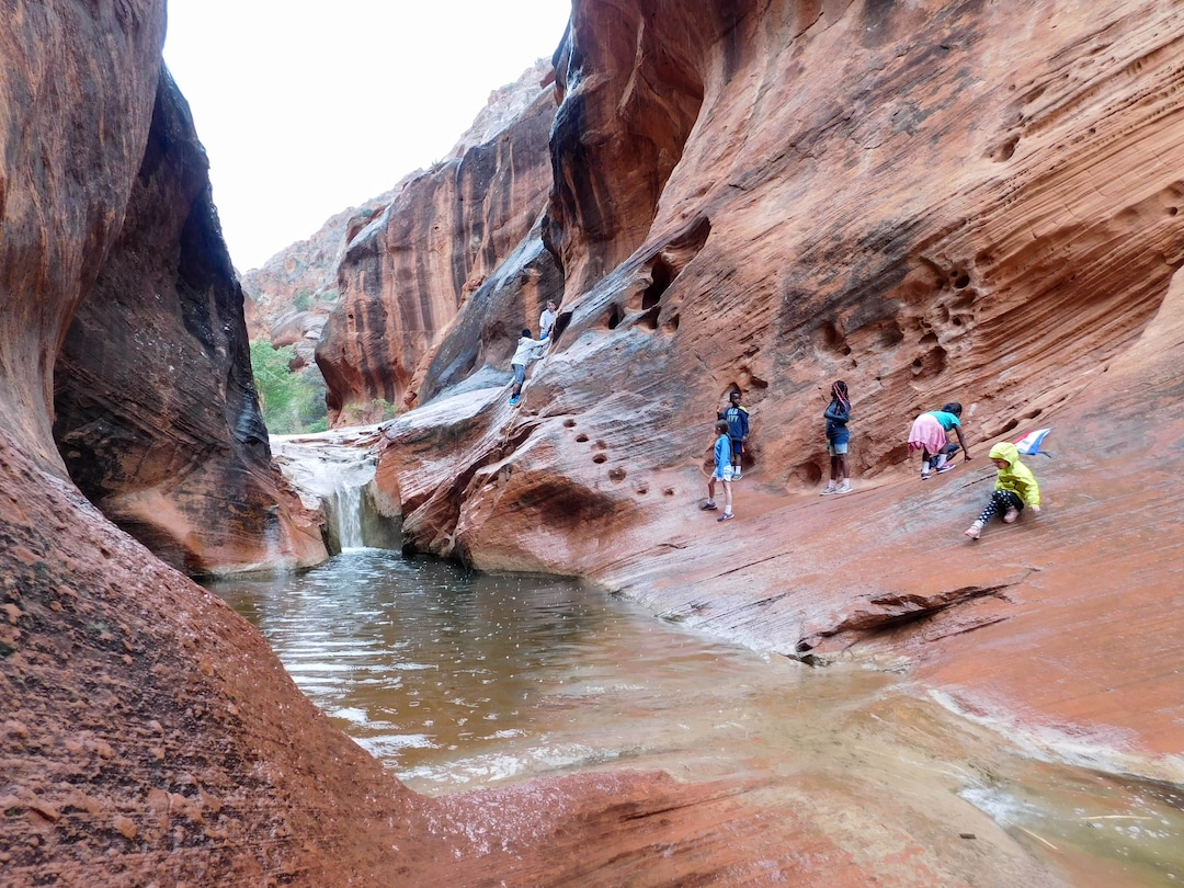 Erin Alberty  |  The Salt Lake TribuneHikers climb on rocks next to the Quail Creek waterfall April 3, 2017 on the Red Reef Trail in Red Cliffs Desert Reserve, north of Harrisburg.