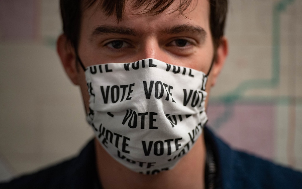 (Francisco Kjolseth | The Salt Lake Tribune) Sam Stamos, support staff for the Salt Lake County clerk’s office sports a “vote” mask made by a colleague on the first day of the state’s in-person voting at the Salt Lake County Government Center on Tuesday, Oct. 20, 2020.