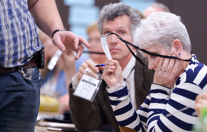 (Leah Hogsten  |  The Salt Lake Tribune)  Salt Lake County delegates Troy L. Muir and Barbara Thomas in House  District 41 show their credentials to legislative chair Reed Taylor during the tallying of votes for candidates Mike Winder and Fred Cox at the Salt Lake County Republican Party Organizing Convention at Cottonwood High School, Saturday, April 14, 2018. 